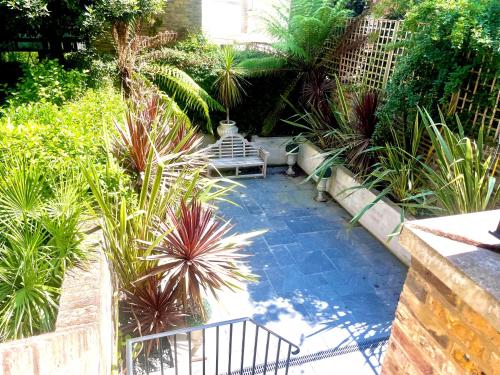 a garden with a staircase and some plants at Luxury 4 Bedrooms 5 Baths 2 Receptions Family House with Garden Chelsea in London