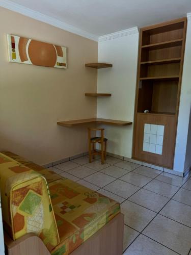 a bedroom with a bed and a table and a chair at Nobreza Fiori Turismo em Caldas Novas Diroma Fiori SEM ROUPAS DE CAMA BANHO E REFEIÇÕES A SEREM CONTRATADAS SEPARADAMENTE DA RESERVA in Caldas Novas
