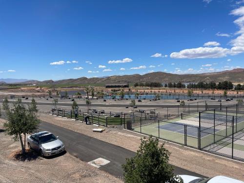 a car parked in a parking lot with tennis courts at Zion Utah Jellystone Park in Hurricane