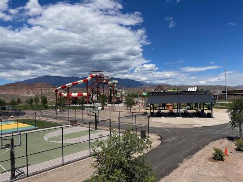 a playground with a roller coaster in a park at Zion Utah Jellystone Park in Hurricane