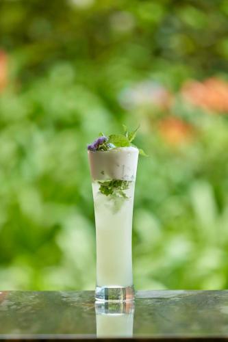 a vase with a plant in it sitting on a table at Terra Nostra Garden Hotel in Furnas