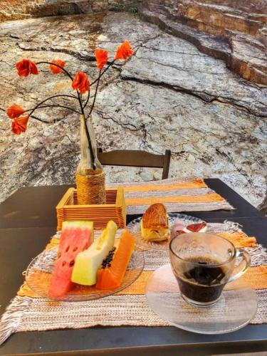 a table with a plate of food and a cup of coffee at Pousada Marotta in Ouro Preto