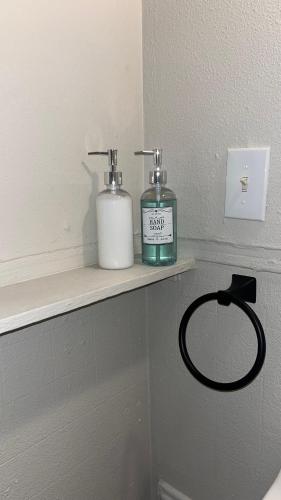 two bottles ofodorizers sitting on a shelf in a bathroom at Hideaway at Columbia in Shreveport