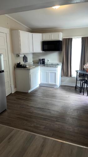a kitchen with white cabinets and a table in a room at Hideaway at Columbia in Shreveport