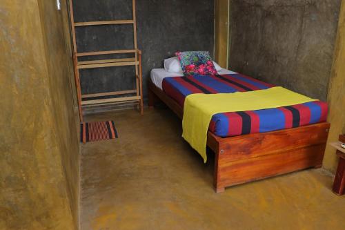 a bedroom with a bed and two bunk beds at Negombo The Nature Villa and Cabanas in Negombo