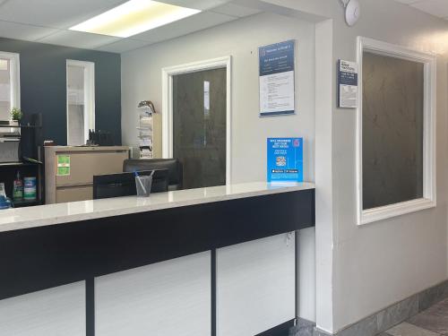 a cashier counter in a waiting room at Motel 6 Norfolk, VA East Little Creek in Norfolk