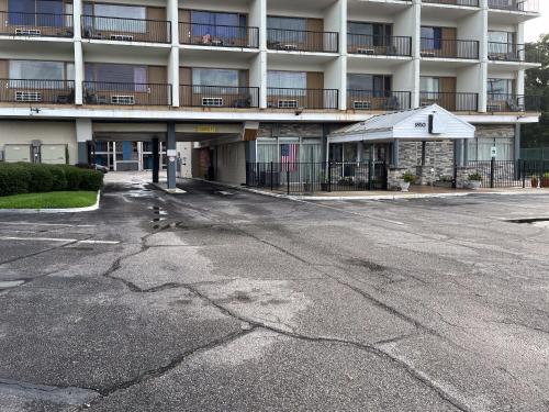 an empty parking lot in front of a building at Motel 6 Norfolk, VA East Little Creek in Norfolk