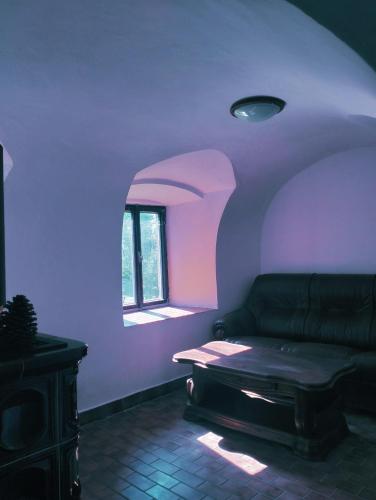 a living room with a couch and a window at Chalupa Vagner, Pernek in Horní Planá