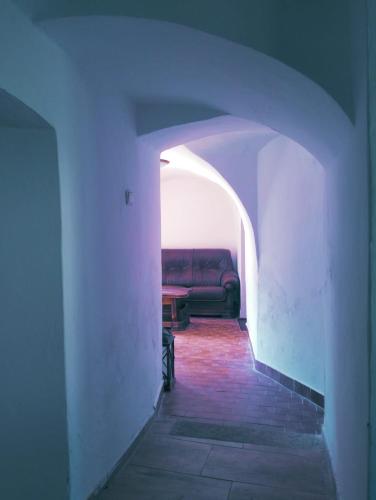a red couch sitting in an archway in a room at Chalupa Vagner, Pernek in Horní Planá