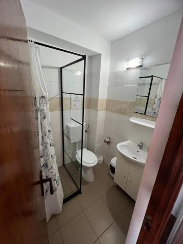 a bathroom with a toilet and a sink and a shower at Vila SIA Eforie Sud in Eforie Sud