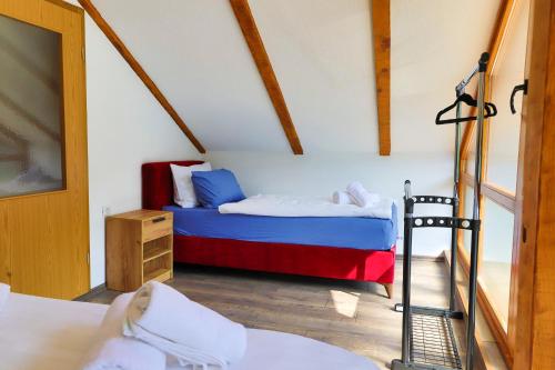 a bedroom with a bed and a ladder in a room at Holiday Homes Mujo Bejzin in Račić
