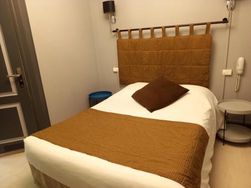 a bedroom with a large bed with a brown blanket at Brit Hotel Comtes De Champagne - Troyes Centre Historique in Troyes