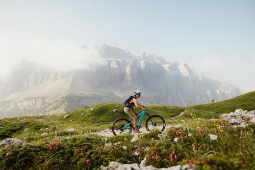 a person riding a bike on a mountain at Hotel Jägerhof in Colfosco