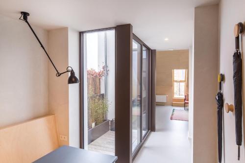 a room with a glass door leading to a living room at The Hide in Ghent
