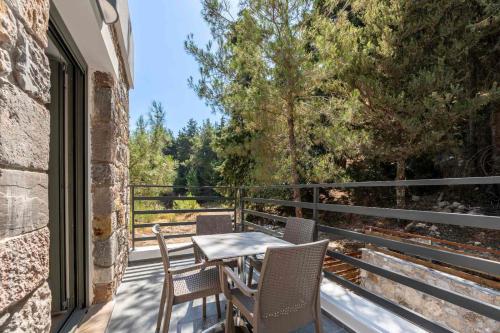 a patio with a table and chairs on a balcony at Sunny Rock Apartments in Asfendioú