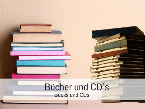 a stack of books and cds on a shelf at Historisches Gerberhaus in Alpirsbach