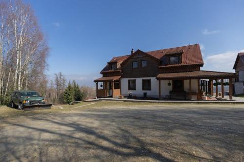 a house with a car parked in front of it at Widokowa Osada in Międzylesie