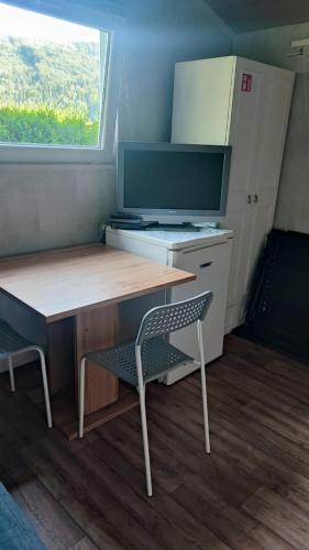 a room with a desk and a chair and a tv at Śniegocinka 2 in Brenna