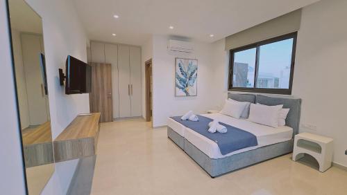 a bedroom with a bed with two towels on it at STAY Oasis Luxury Villas in Ayia Napa