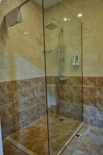 a shower with a glass door in a bathroom at Square Boutique Hotel in Baku