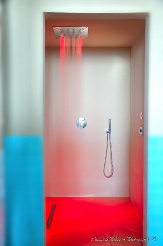 a bathroom with a shower with a shower head at Relais La Colombara Spa & Wellness in Travo