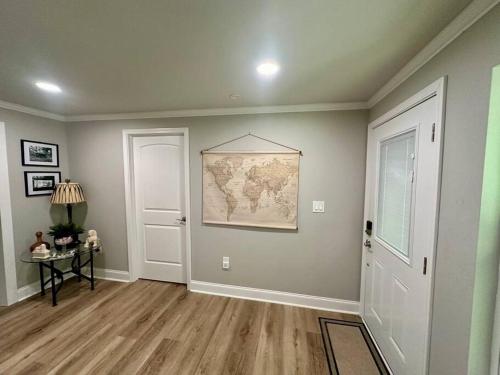 a living room with a map on the wall at Secluded Riverside Oasis Private Deck Dock in Baton Rouge