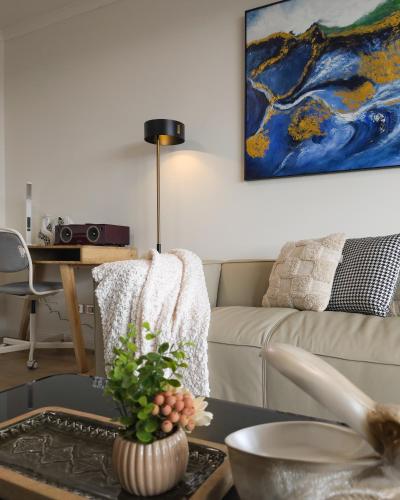 a living room with a couch and a table at Chic Darling Harbour Oasis in the Heart of Sydney, 2BR 2BA, Resort-Style Amenities in Sydney