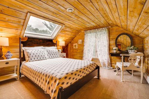 a bedroom with a bed and a wooden ceiling at Picturesque Lake Elmo Cottage with Fire Pits! in Lake Elmo