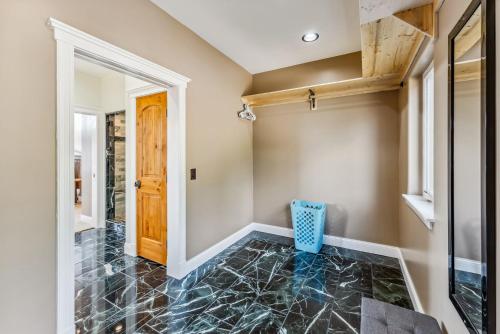 a hallway with a door and a tile floor at Custom 2BR & Loft Home, with Hot Tub & Stunning Views in Alma