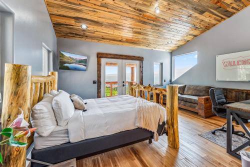 a bedroom with a bed and a living room at Custom 2BR & Loft Home, with Hot Tub & Stunning Views in Alma