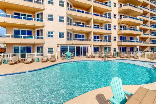 a swimming pool in front of a apartment building at The Enclave 606 in Orange Beach