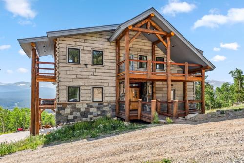a log home on a hill with a view at Custom 2BR & Loft Home, with Hot Tub & Stunning Views in Alma