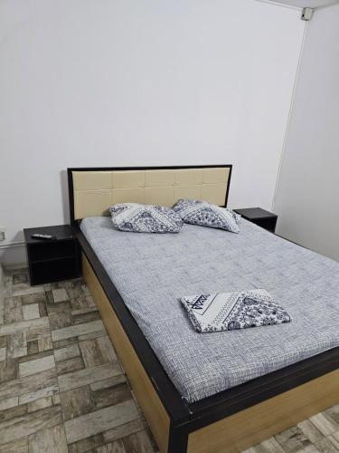 a bedroom with a bed with two pillows on it at Holiday Village in Eforie Nord