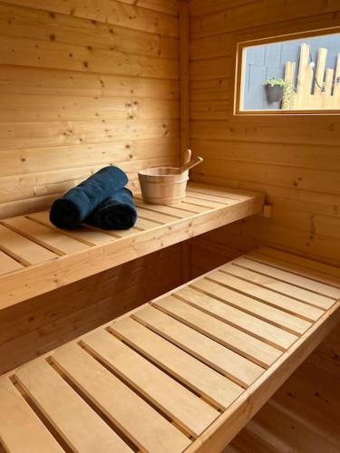 - un sauna en bois avec une baignoire et un bol dans l'établissement Sauna et SPA en rez-de-jardin au pied de la montagne, à Buhl