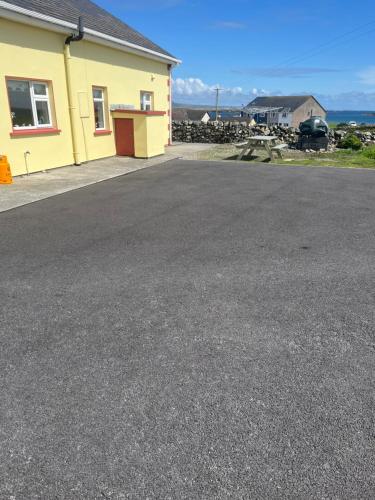 an empty parking lot in front of a house at Pier view house in Ballyconneely
