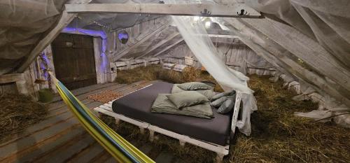 a bedroom with a bed in a tent at Lighthouse Benki in Užava