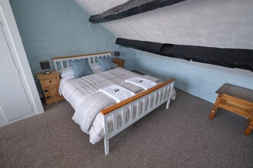 a bedroom with a bed with two towels on it at Olivia Cottage - a Home From Home by the Sea in Morecambe