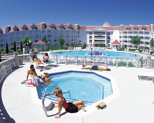 a group of people sitting around a pool at a resort at Primm Valley Hotel & Casino, a Travelodge by Wyndham in Primm