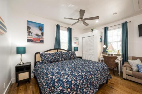 a bedroom with a bed and a chair and a desk at The Speakeasy Inn and Rum Bar in Key West