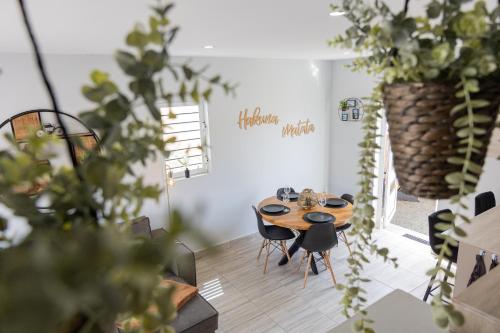 a table and chairs in a room with plants at Av Curacao - Centrally Located Spacious Apartment in Willemstad