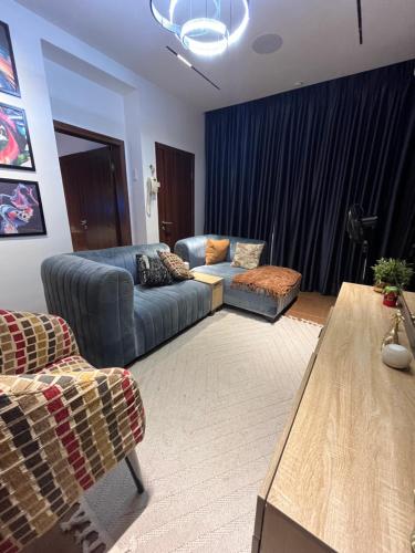 a living room with a couch and a table at Luxury One Bedroom Furnished Apartment in Abuja