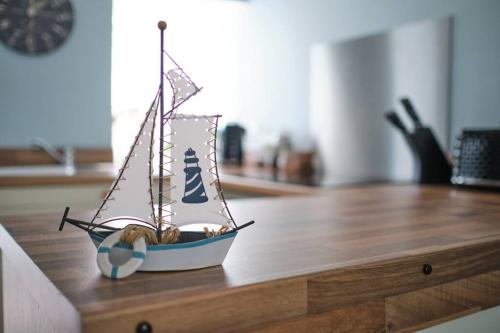 a toy boat sitting on top of a wooden table at Evie Cottage - The peaceful Retreat in Morecambe