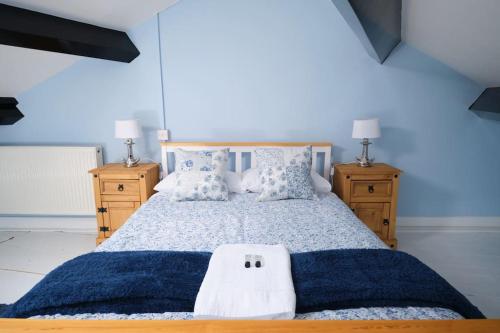 a bedroom with a large bed and two night stands at Evie Cottage - The peaceful Retreat in Morecambe