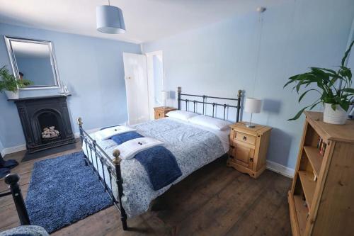 a bedroom with a bed and a fireplace at Evie Cottage - The peaceful Retreat in Morecambe