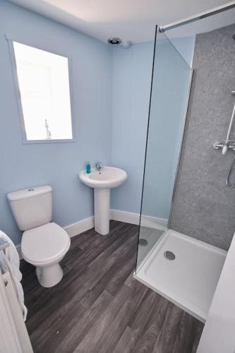 a bathroom with a toilet and a sink at Evie Cottage - The peaceful Retreat in Morecambe