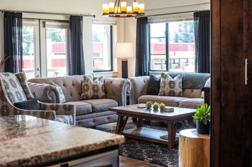 a living room with a couch and a table at Downunder Mountain Retreat in Revelstoke