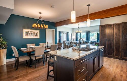 a kitchen and dining room with a table and chairs at Downunder Mountain Retreat in Revelstoke