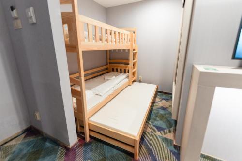 a small room with a bunk bed in a room at Science Hotel Prémium in Szeged