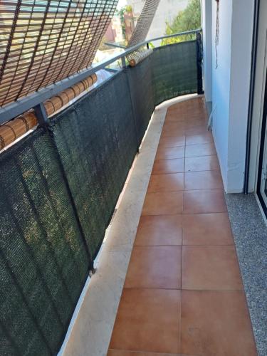 a balcony with a fence and a tiled floor at Borgo Marino casa vacanze in Santa Teresa di Riva