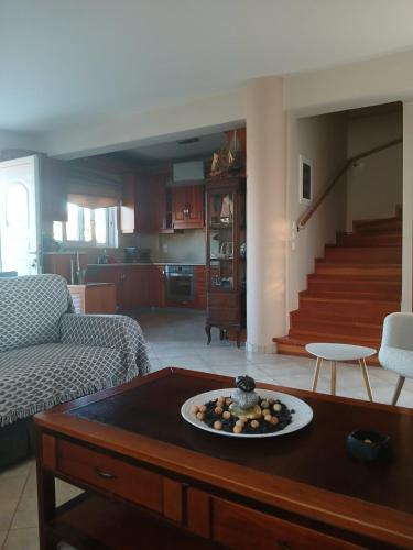 a living room with a table with a plate on it at Homey Family ArtAki in Néa Artáki